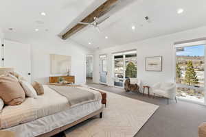 Carpeted bedroom with access to outside, vaulted ceiling with beams, and ceiling fan