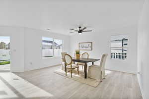 Dining space featuring light wood-type flooring, plenty of natural light, and ceiling fan