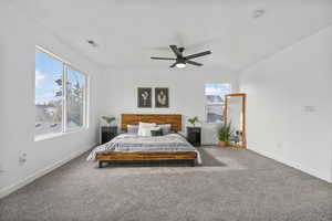 Carpeted bedroom featuring ceiling fan