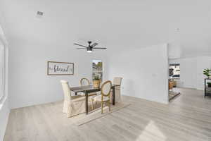 Dining room with ceiling fan, a healthy amount of sunlight, and light wood-type flooring