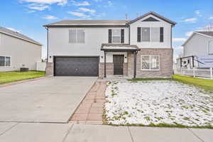 Front of property with a garage and cooling unit