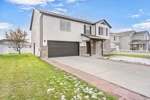 View of front facade with a front yard and a garage