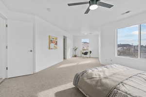 Bedroom featuring ceiling fan and light colored carpet