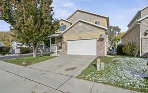 View of front of home featuring a front yard and a garage