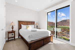 Carpeted bedroom with a mountain view