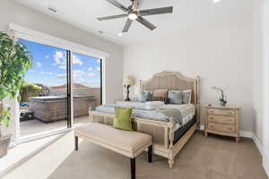 Carpeted bedroom featuring access to exterior and ceiling fan