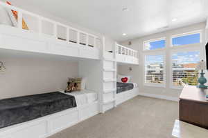 Carpeted bedroom featuring a textured ceiling