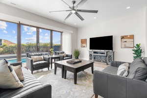 Living room featuring ceiling fan and light wood-type flooring