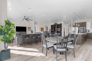 Dining area featuring light hardwood / wood-style floors, ceiling fan, and sink