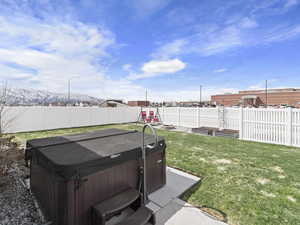 View of yard with a playground and a hot tub