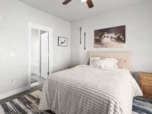 Carpeted bedroom with ensuite bathroom and ceiling fan