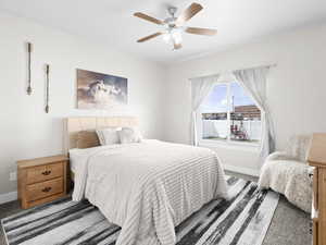 Carpeted bedroom featuring ceiling fan