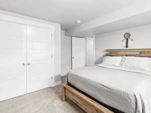 Carpeted bedroom featuring a closet and a textured ceiling