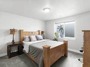 Carpeted bedroom featuring a textured ceiling