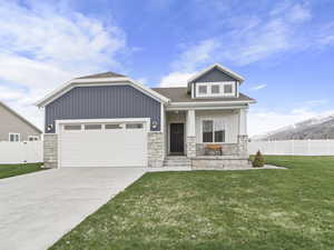 Craftsman inspired home featuring a front yard and a garage