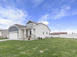 Craftsman-style house with a garage and a front lawn