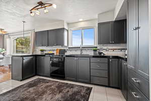 Kitchen with dishwasher, tasteful backsplash, and a wealth of natural light