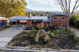 Tri-level home with a mountain view and a carport