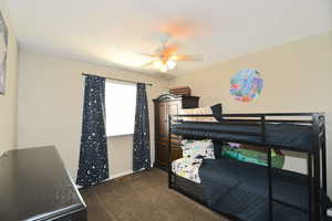 Carpeted bedroom with ceiling fan