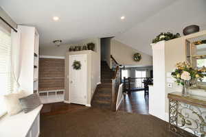 Interior space with hardwood / wood-style floors and lofted ceiling