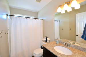 Bathroom featuring vanity and toilet