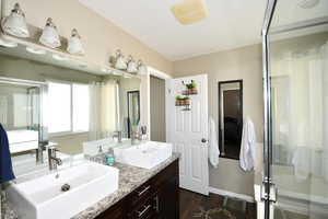 Bathroom featuring a shower with door, vanity, and hardwood / wood-style flooring