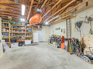 Garage with white fridge and a garage door opener