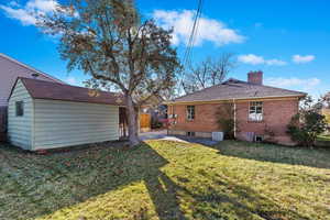 Back of house featuring a yard and a patio