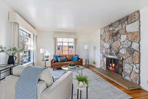 Living room featuring hardwood / hardwood floors, plenty of natural light, and a fireplace