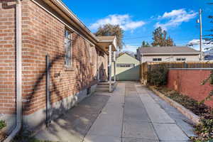 View of side of home featuring an outbuilding and a garage