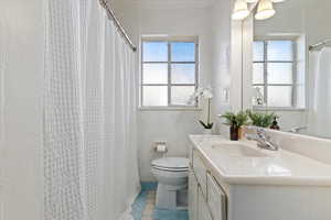 Bathroom with tile patterned floors, vanity, and toilet