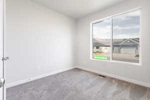 Spare room featuring carpet flooring