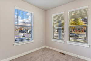 Spare room with carpet and plenty of natural light