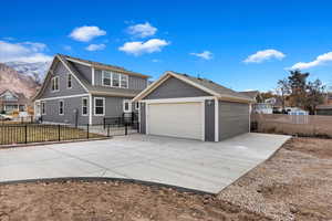 View of front of house featuring a mountain view and a garage