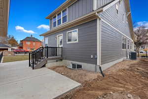 View of side of home with a patio area and cooling unit