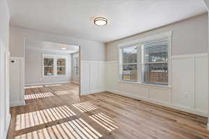 Spare room featuring a textured ceiling and light wood-type flooring