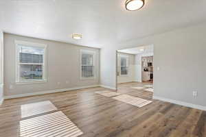 Interior space featuring a textured ceiling and light hardwood / wood-style floors