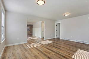 Unfurnished room with light hardwood / wood-style floors and a healthy amount of sunlight