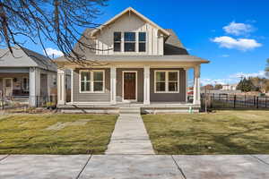 Bungalow featuring a front yard and a porch