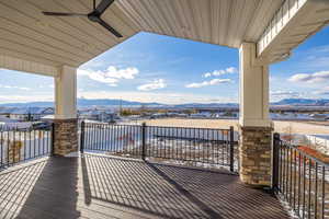 Wooden terrace featuring ceiling fan and a mountain view