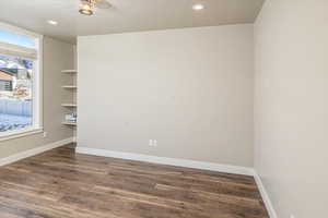 Empty room with dark hardwood / wood-style flooring