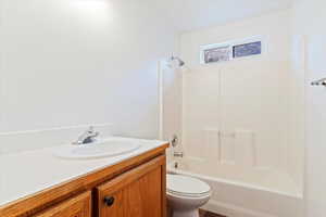 Full bathroom featuring shower / bathing tub combination, vanity, and toilet