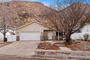 View of front of house with a mountain view and a garage