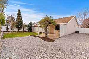 Rear view of house with a patio area and a yard