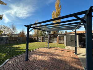 View of patio / terrace with a pergola and a shed