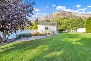 View of yard with a mountain view, an outbuilding, and a patio area