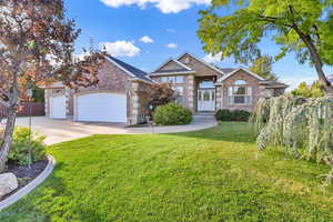 View of front of property with a garage and a front yard