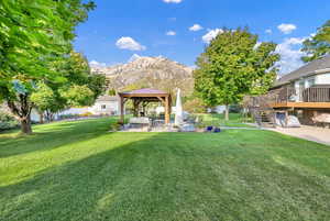 View of yard with a gazebo, a patio area, and a deck with mountain view