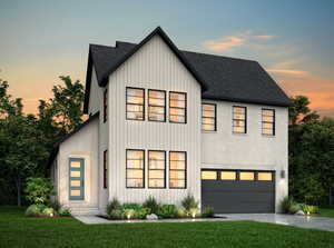 Modern farmhouse featuring a yard and a garage