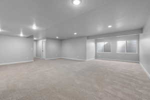 Carpeted empty room featuring a textured ceiling